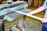 A stringer is sanded in the drum sander
